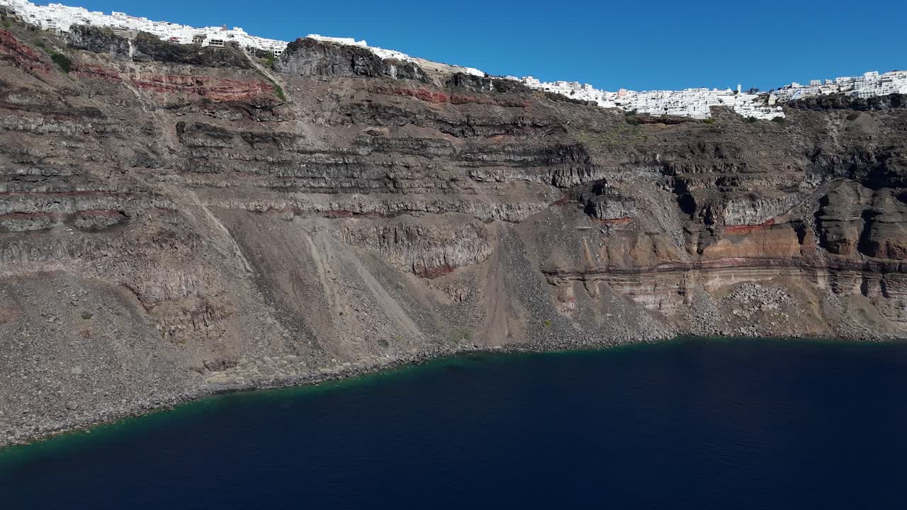 white-washed picturesque town of Fira on Santorini, Greek island lines the coast of a volcanic caldera wall