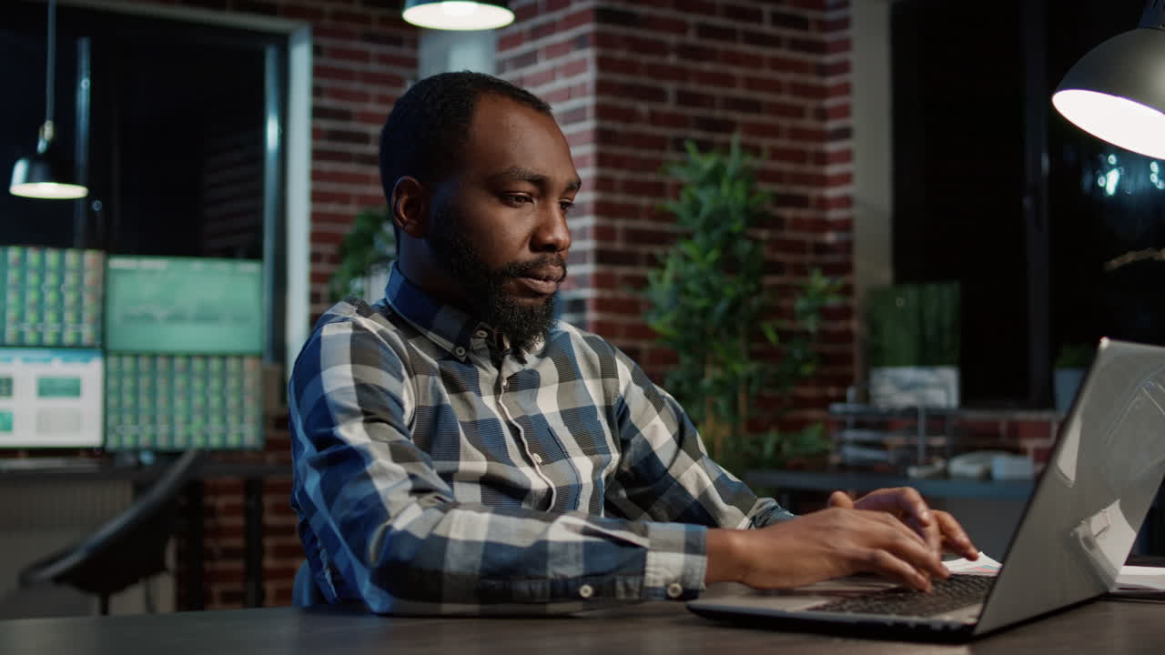 Male investor developing stock market statistics on laptop