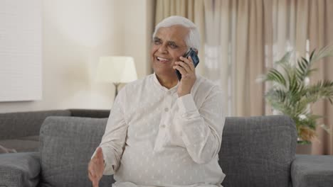 Happy-Indian-old-man-talking-on-phone