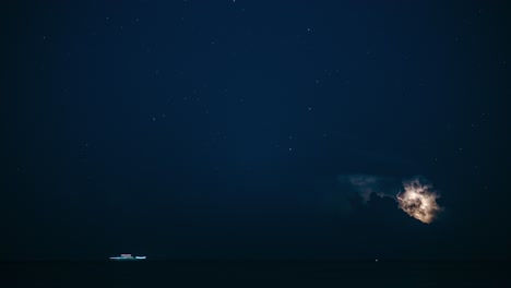 timelapse of large thunderstorm clouds at night in the sea. lightning strikes and ships passing. long exposure timelapse.