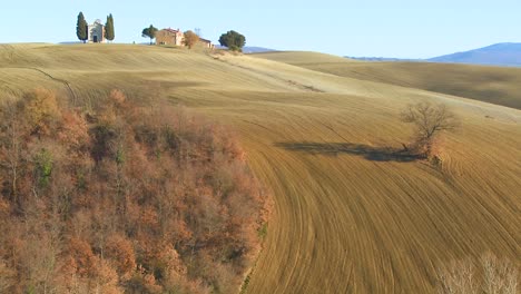 a beautiful farmhouse and church in the distance in tuscany italy 1