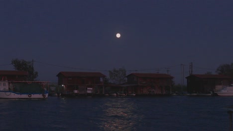 full moon over mussel with night fishermen