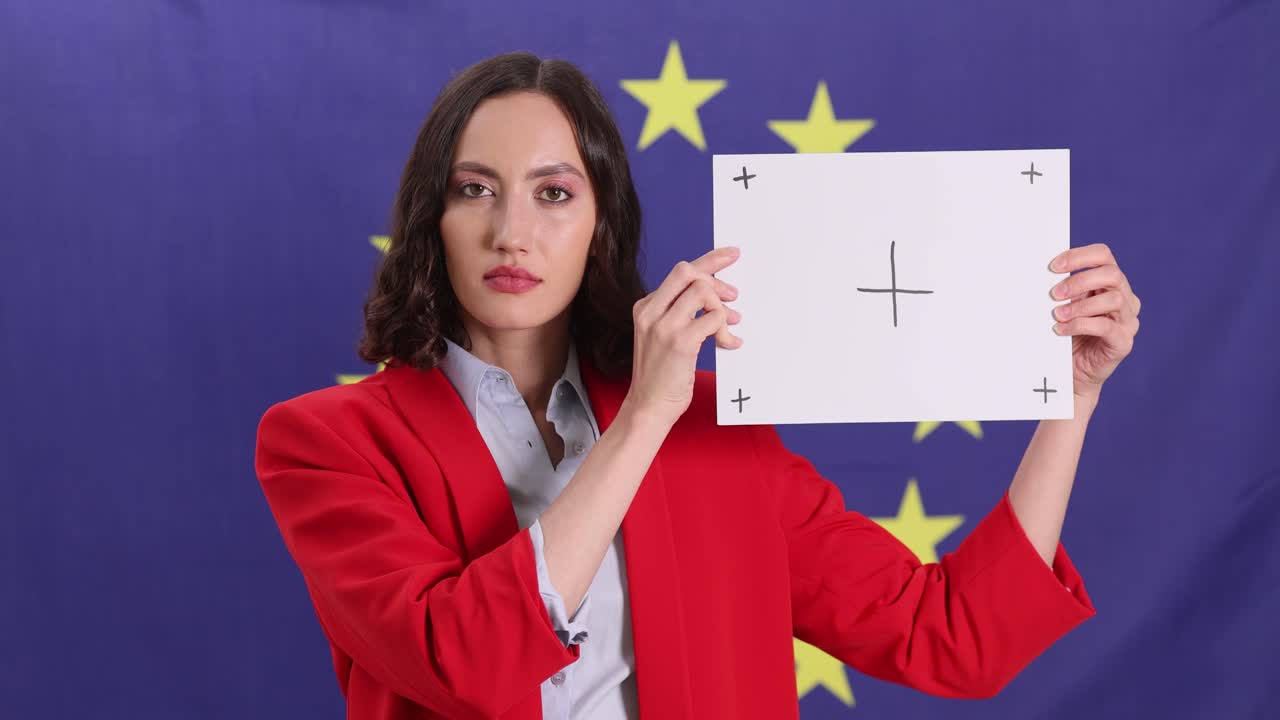 Woman Holding Sign in Front of EU Flag