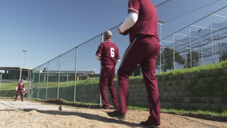 walking on baseball field, man in uniform holding glove and ball