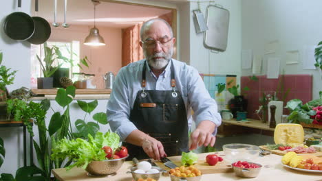 man cooking a healthy salad in the kitchen