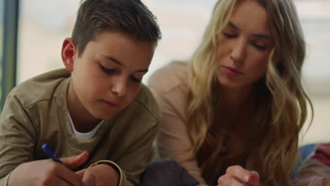 mom helping children with drawing at home