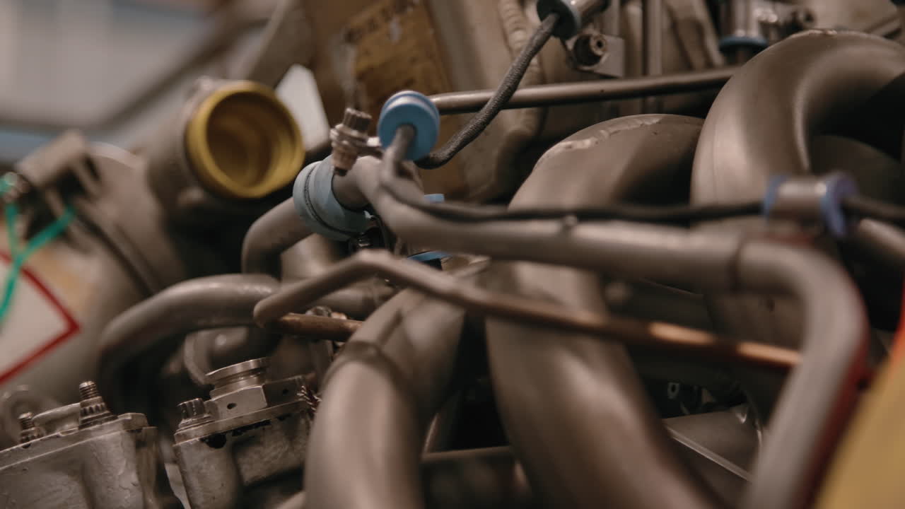 Rack focus across an airplane engine being repaired