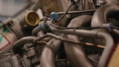 Rack-focus-across-an-airplane-engine-being-repaired