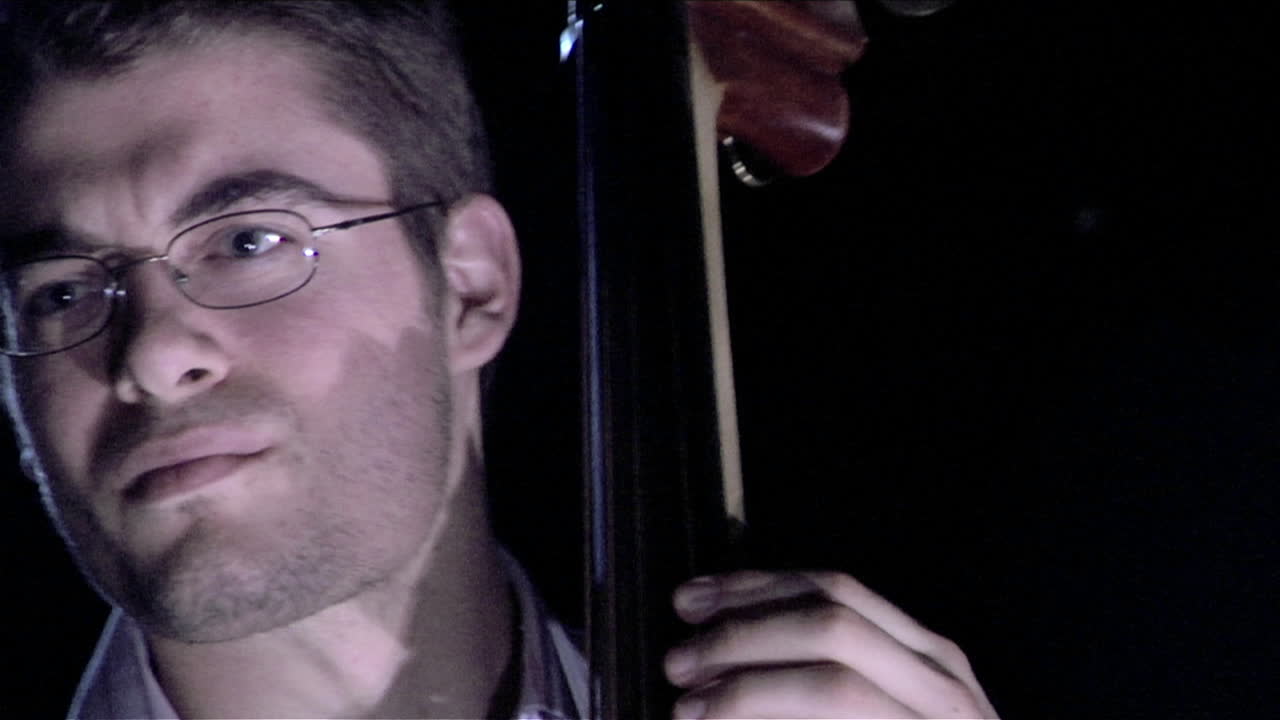 A man plays the bass fiddle