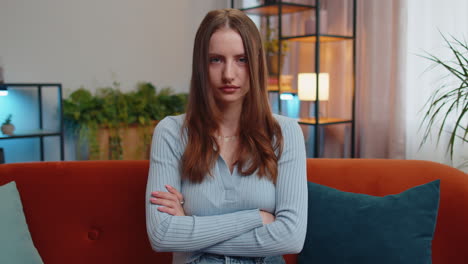 upset young woman showing thumbs down, dislike bad work, disapproval, dissatisfied feedback at home