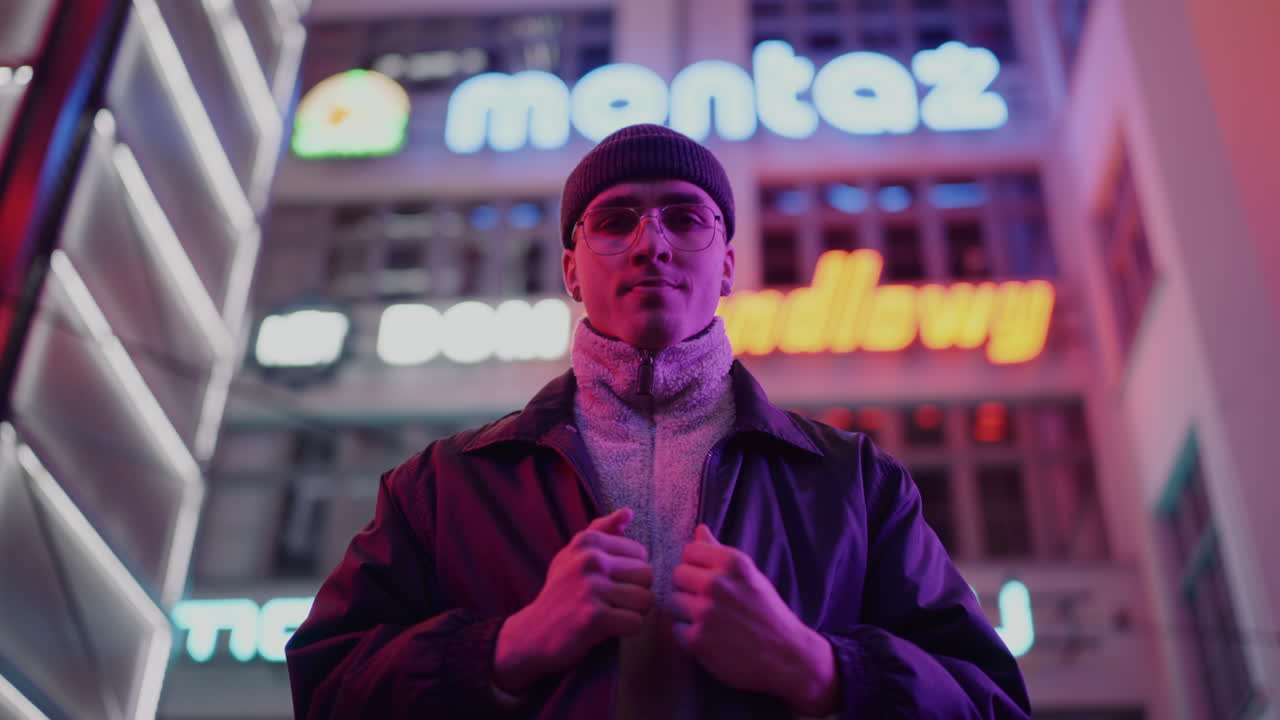 Man in Neon-Lit City at Night