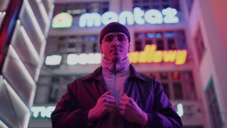 man in neon-lit city at night