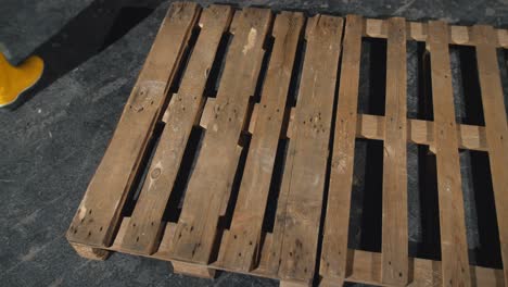 workers handling wooden pallets