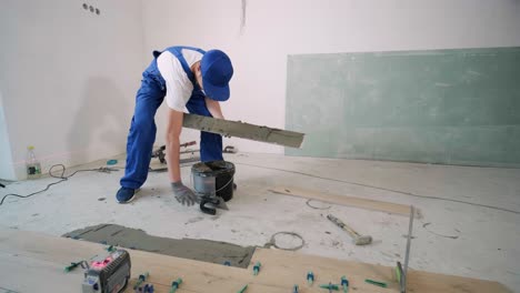 construction, renovation, repair apartment. installing ceramic floor tiles - measuring and cutting the pieces. cuts tile. tile cutting