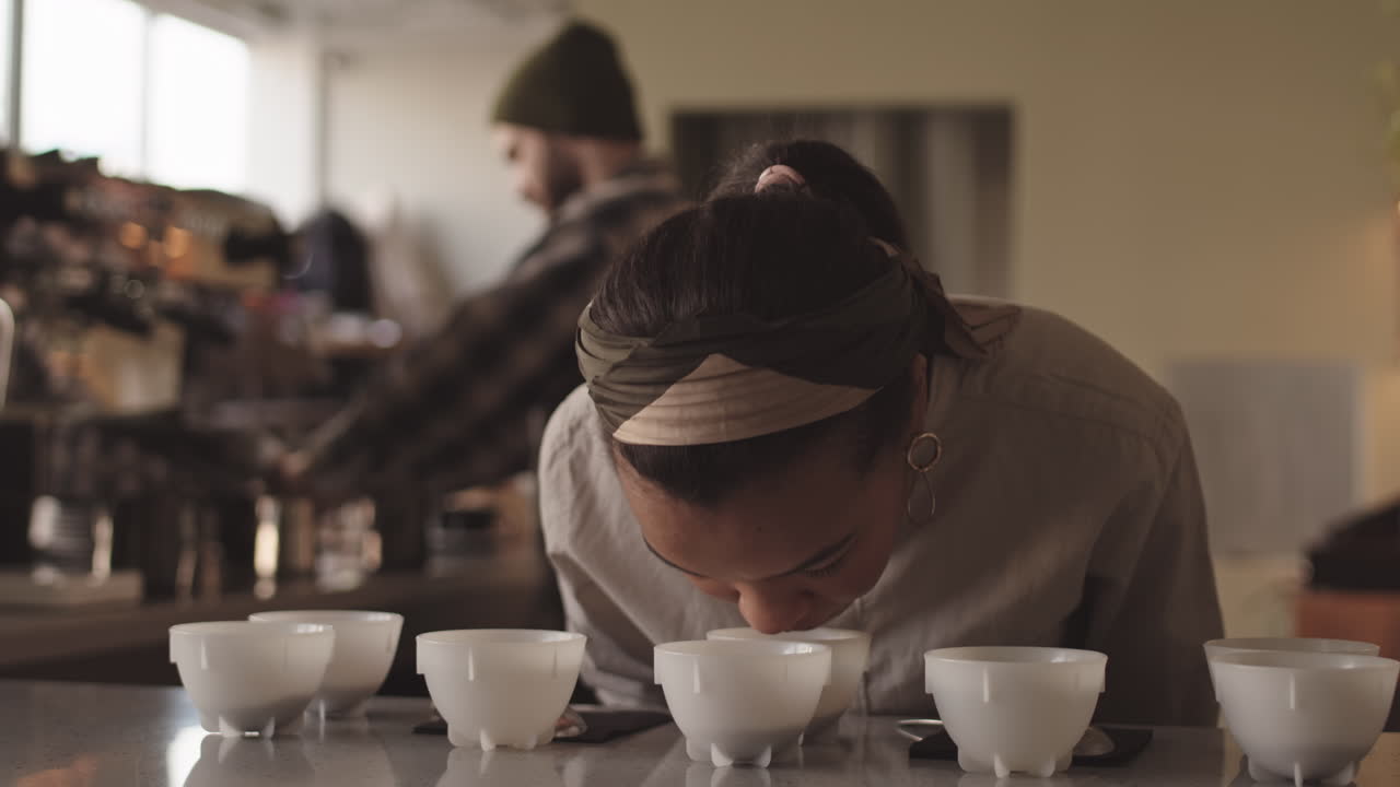 Female Barista Sniffing Different Types of Coffee