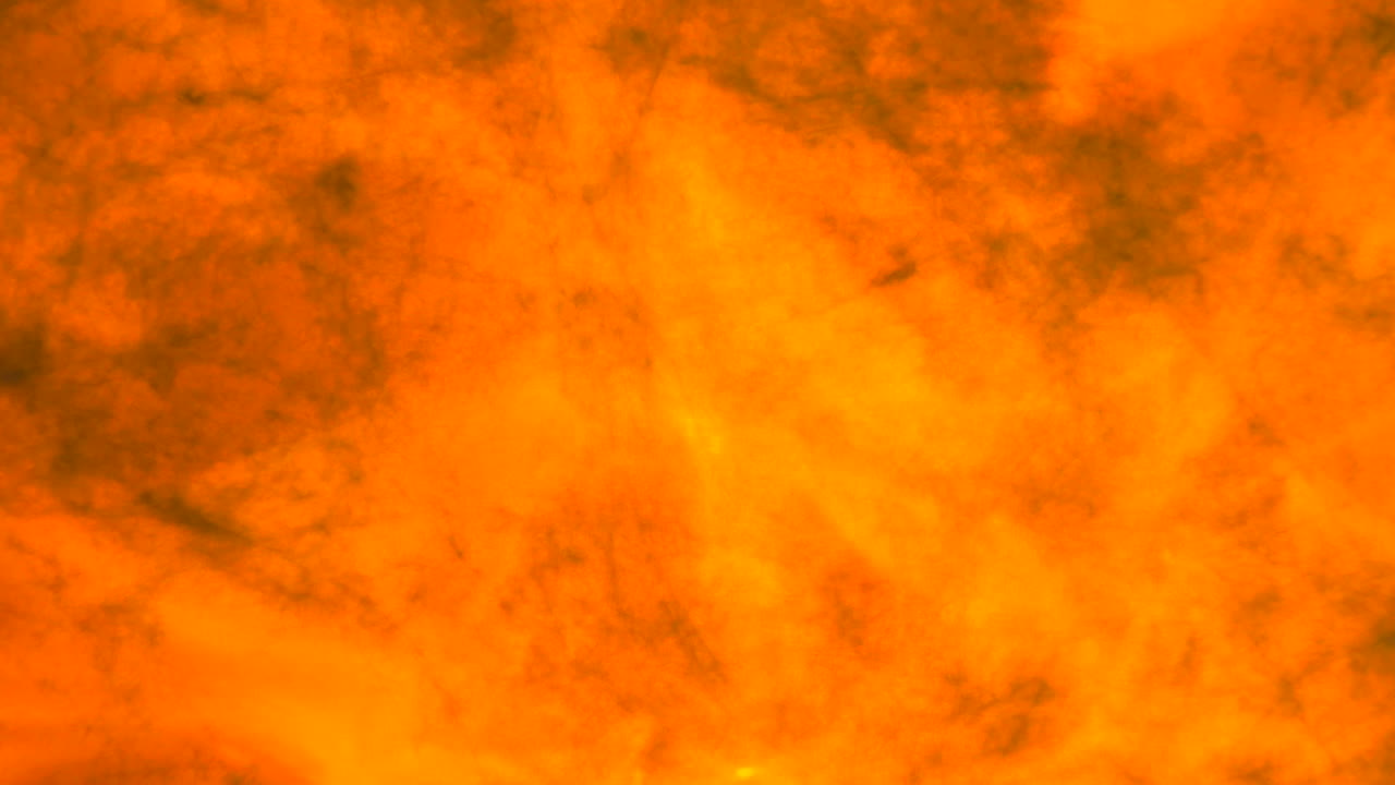 Abstrakt orange och gul bakgrund med glödande varm textur, som framkallar koncept som eld, rök och värme.
