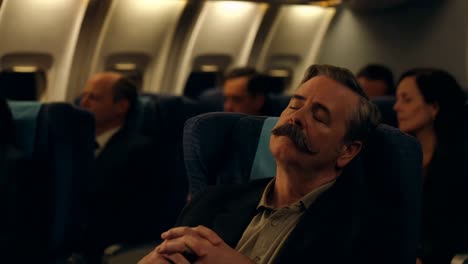 man sleeping on airplane