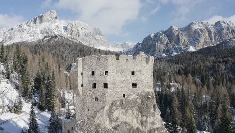 Medieval-ruins-of-castle-Andraz-with-natures-Dolomite-mountains-backdrop-AERIAL