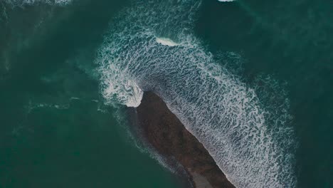 waves crashing over the beach during sunset