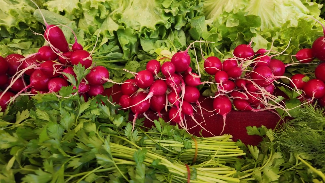 Fresh Radishes and Green Herbs at a Farmers Market