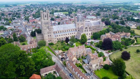 aerial view of ely cathedral with urban cityscape in england, drone rotation shot