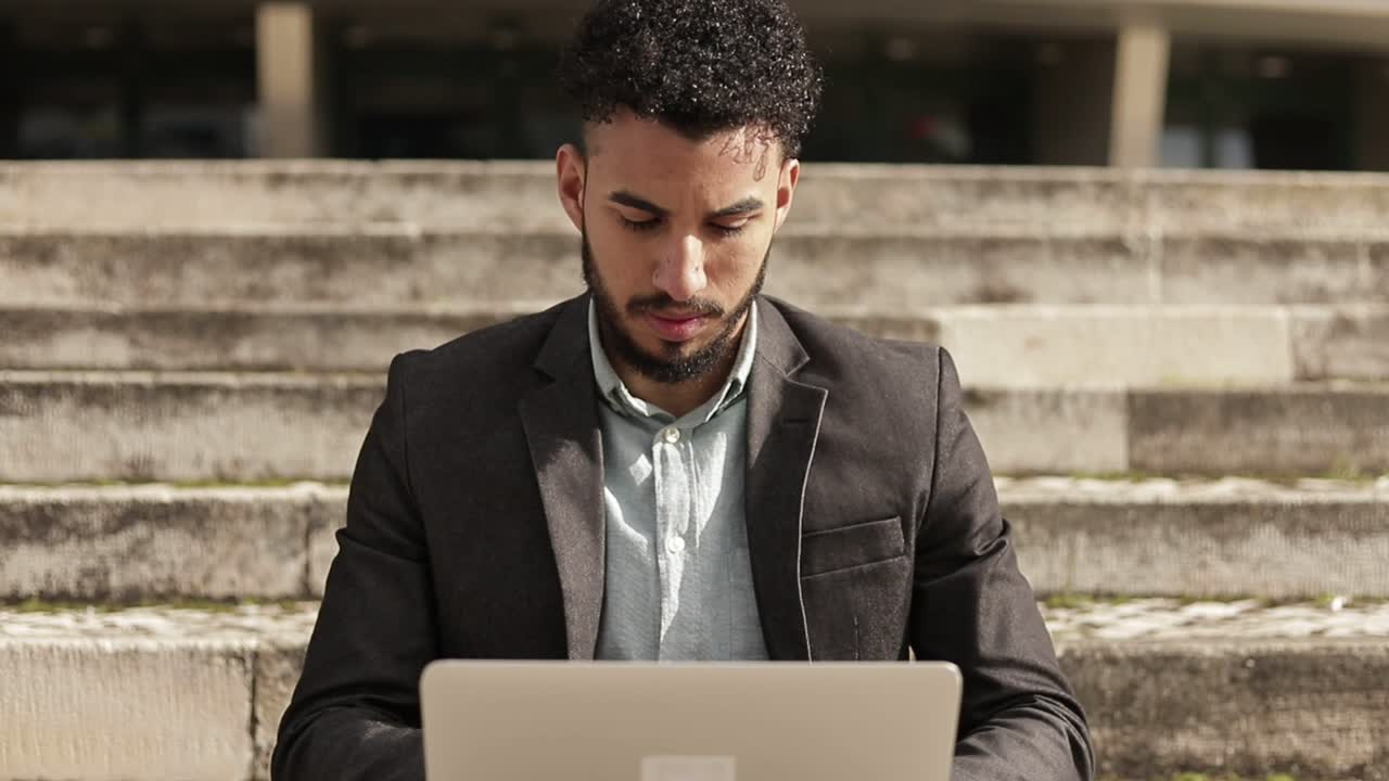 Concentrated handsome man working with laptop