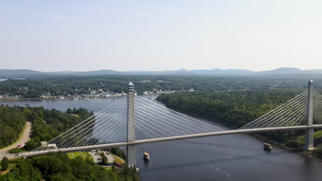 slow aerial ascent showing bridge spanning river at bucksport in maine