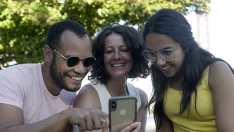 happy friends using smartphone