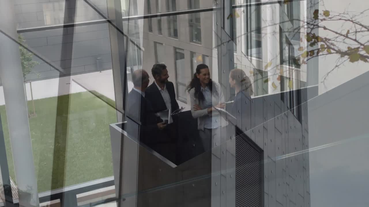 Animation of office building over business people talking in modern office