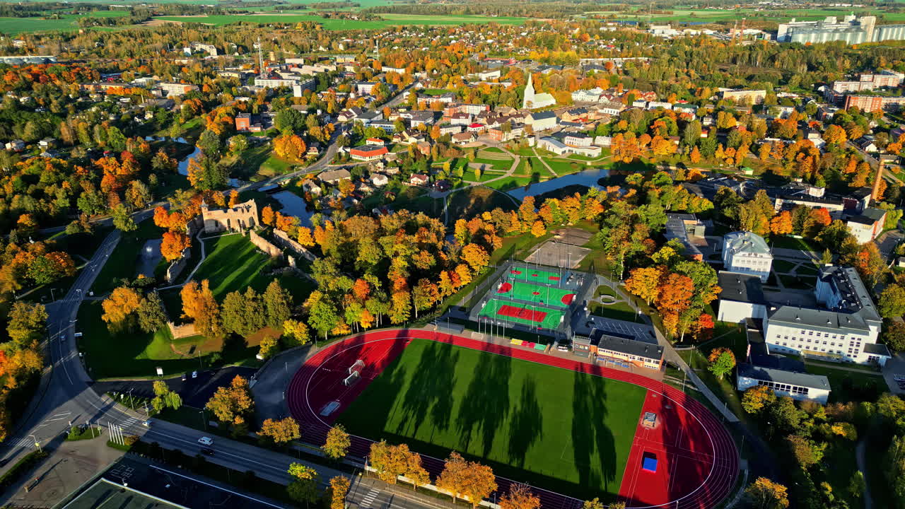 Aerial View of Dobele Castle, Sports Complex, and City Landscape in Autumn Season