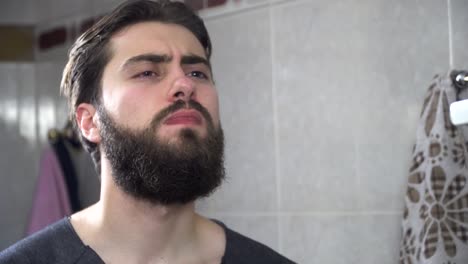 man applying perfume in bathroom