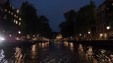 timelapse of traveling on amsterdam canals at night