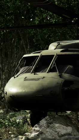 military helicopter rests quietly in the dense forest during a stealth mission