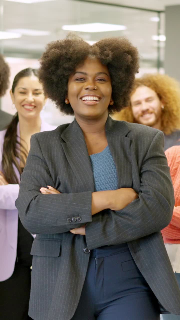 African female boss leading employees in a coworking