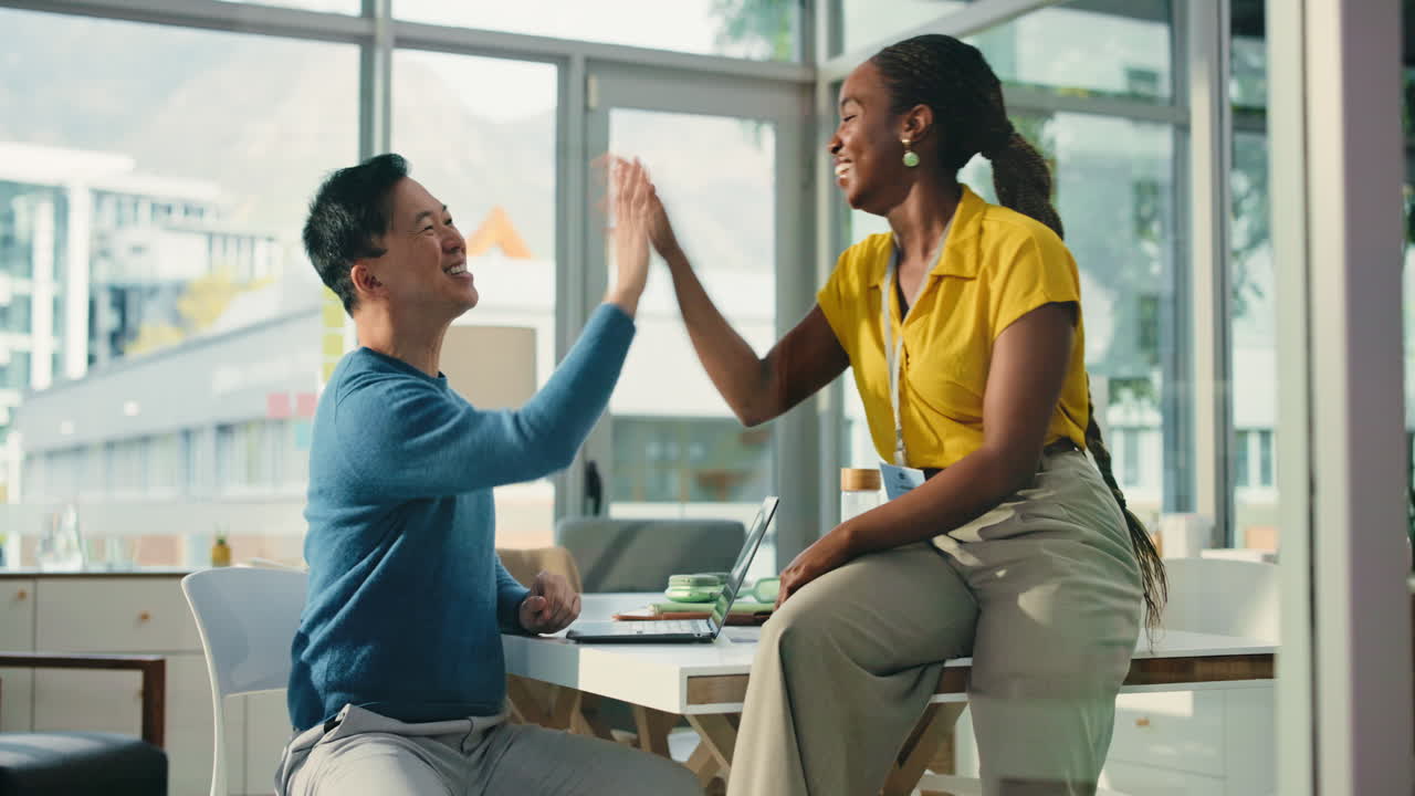 Diverse Business Colleagues High-Fiving and Collaborating in Office