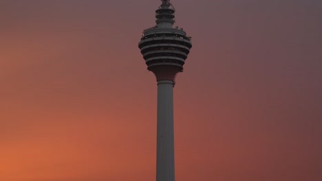 vibrant-colorful-sunset-into-dusk-shot-of-KL-Tower-from-a-rooftop-bar-in-Kuala-Lumpur,-Malaysia