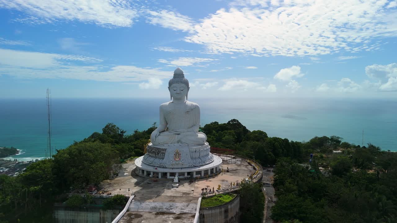 Aerial orbit right circles Phuket Big Buddha with wide coastal Andaman views