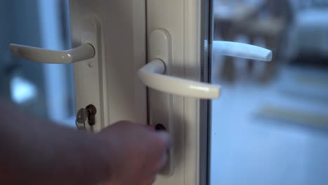 White-conservatory-door-being-closed-and-locked