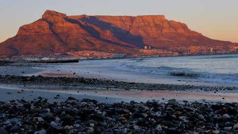 sun rays lighting up table mountain in cape town during sunrise