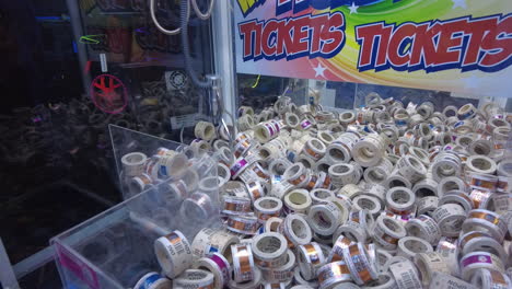 claw machine at an arcade grabbing tickets