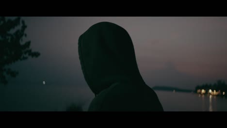person in a hoodie at dusk