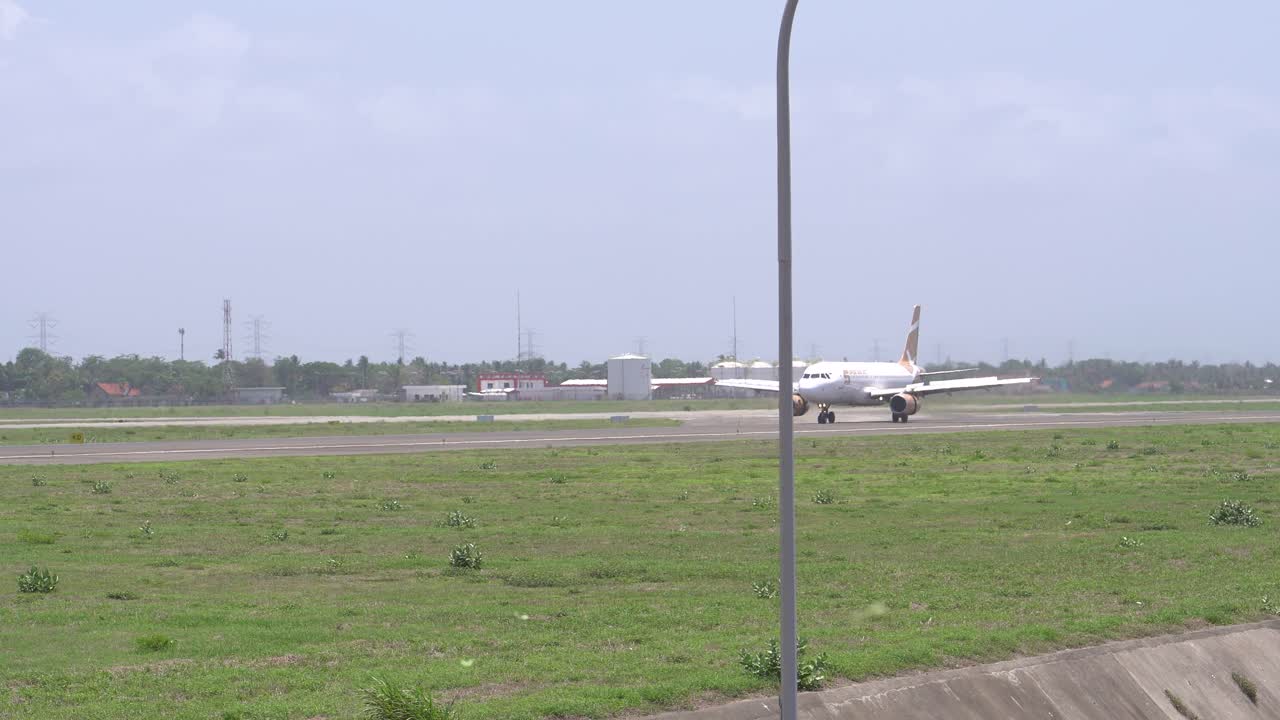 The atmosphere of the runway at Yogyakarta International Airport, a commercial Super Air Jet aircraft is seen landing.