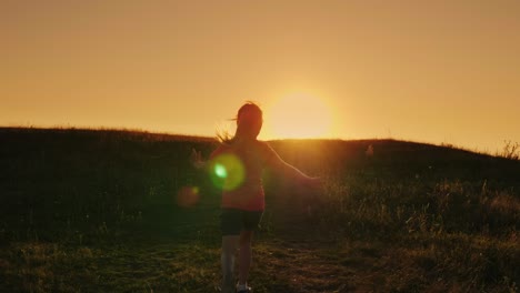 carefree girl skipping fun at sunset. back view. concept - a happy childhood, energetic youth