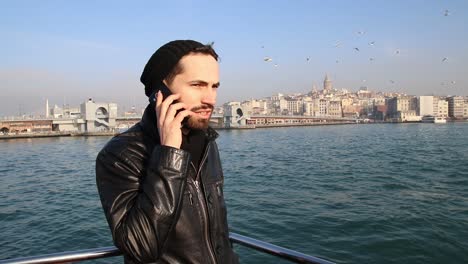 Young-Man-Having-Conversation-With-Smartphone