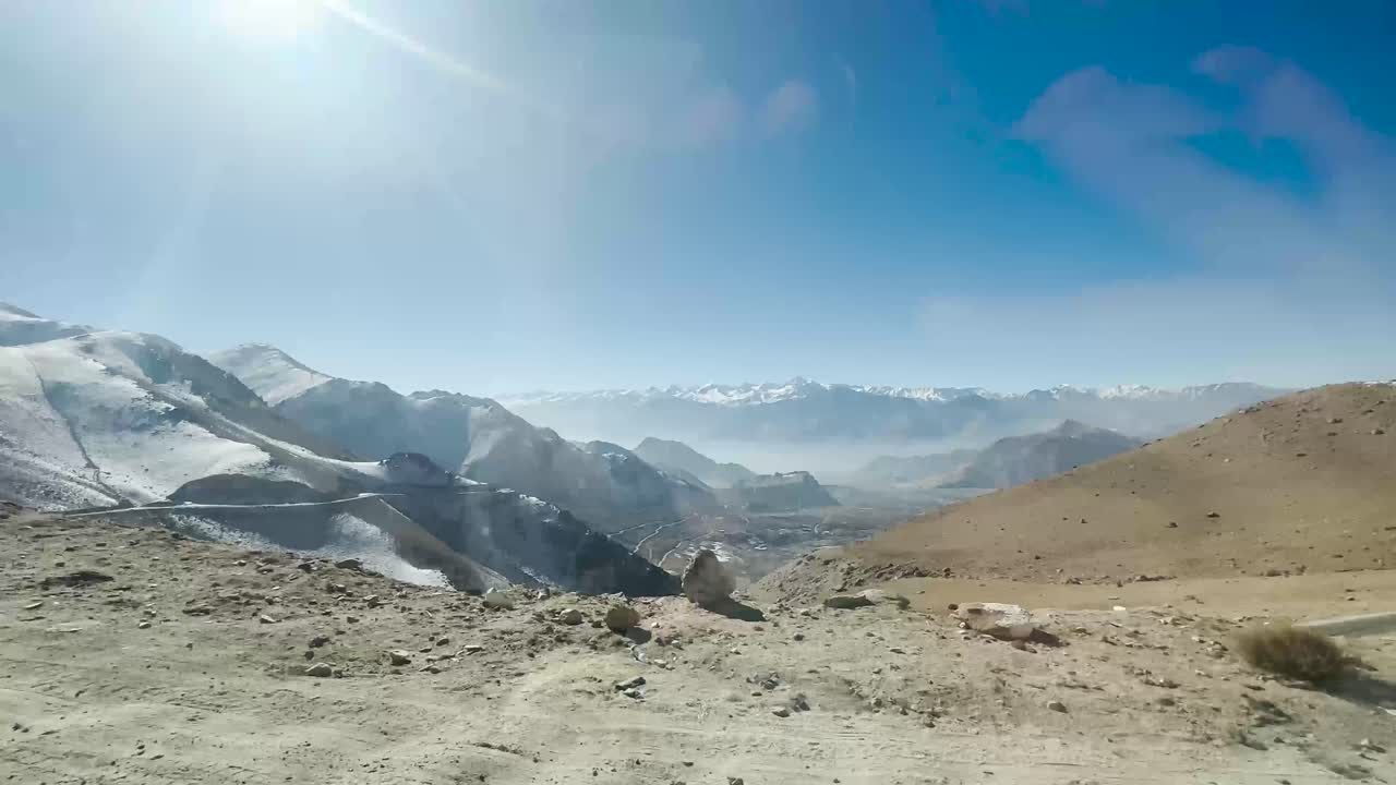 wide shot of Himalayas mountains valley cinematic camera zoom in or out at running car.