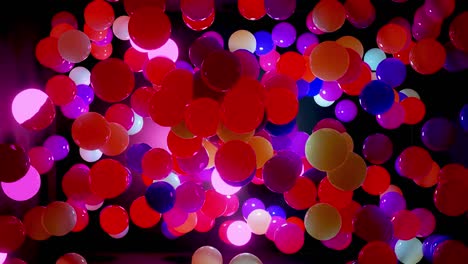 abstract composition of colorful balls in air, which randomly light up and reflect in each other. multicolored spheres in air as simple geometric dark background with light effects.