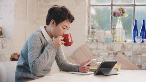 young student using smart phone at home in  morning drinking coffee