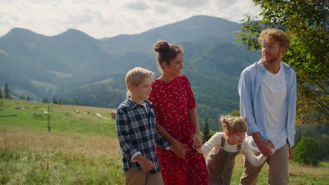 happy family trip nature on summer weekend. people speaking smiling on walk.