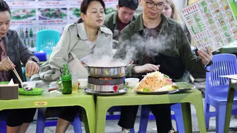 group enjoys communal hot pot dining experience