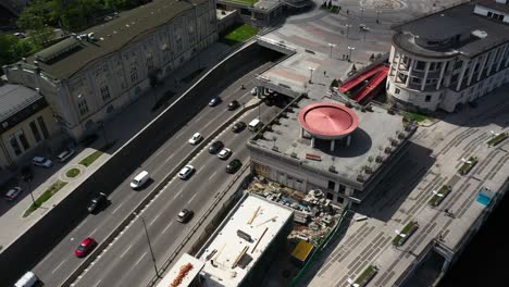 cityscape with highway, construction, and restaurant rooftop
